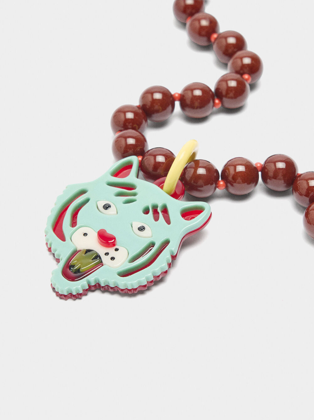Necklace of beads with tiger pendant