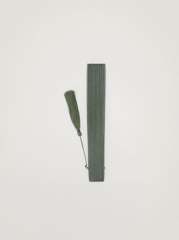Perforated fan with tassel