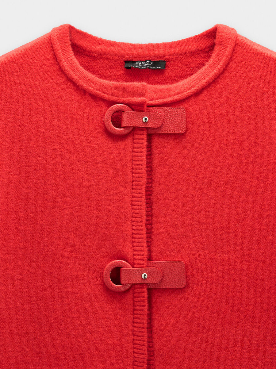 Knit poncho with buckles