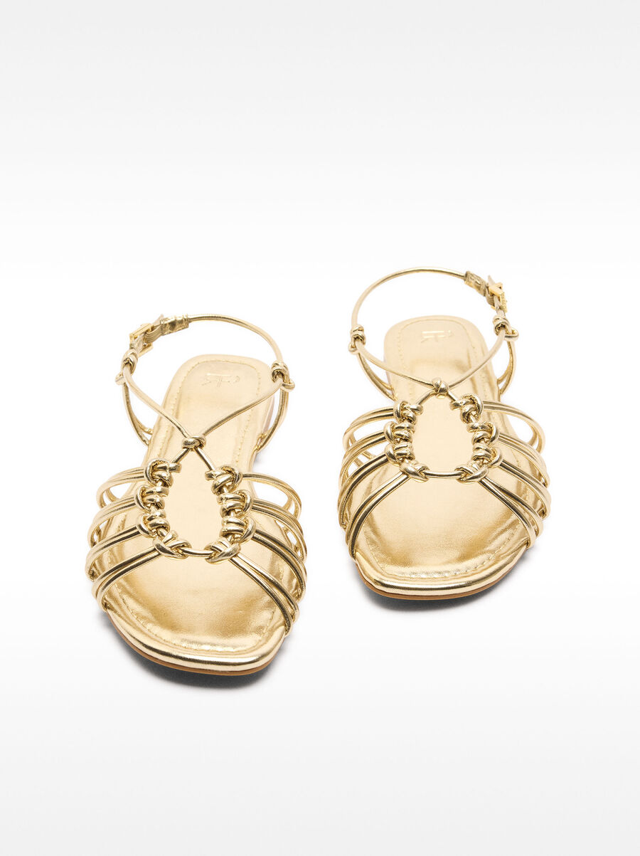Metallic flat sandals with straps and knots