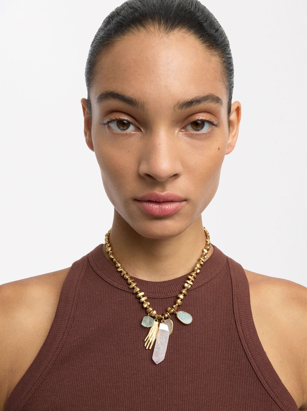 Necklace with hand and stone pendants