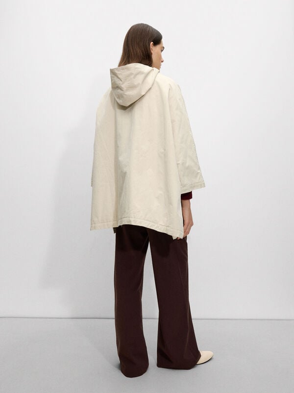Cape with hood and pockets
