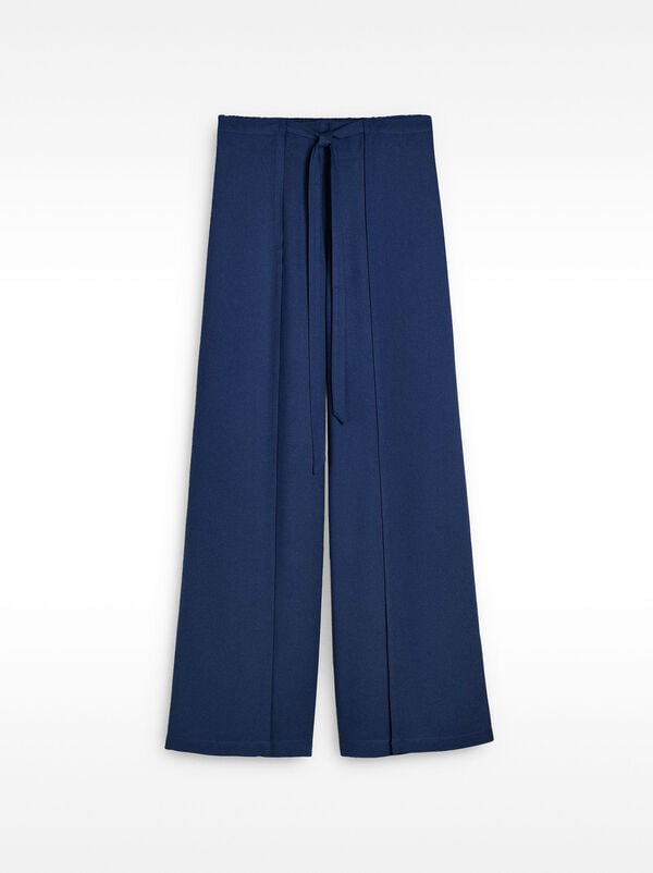 Fluid trousers with side overlaps