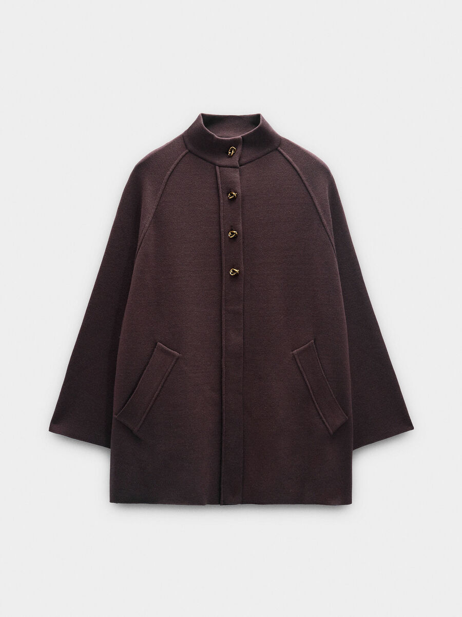 Knit poncho with high neck