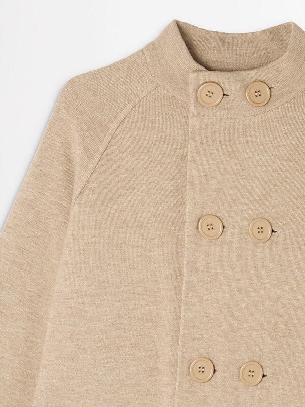 Knitted poncho with buttons