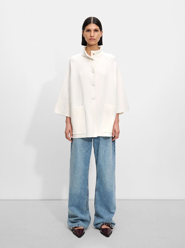 Knitted poncho with buttons
