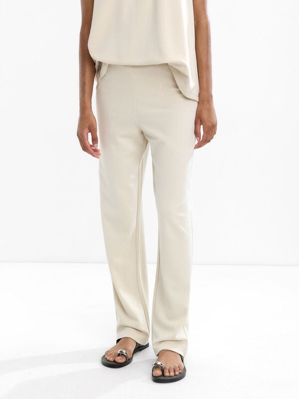 Pleated trousers with elastic waist