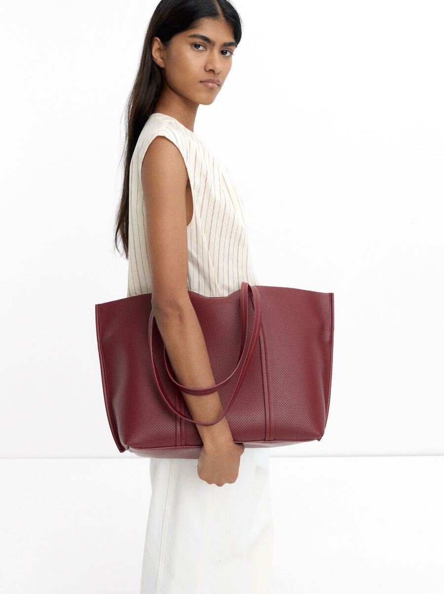 Perforated shopper bag with removable pouch
