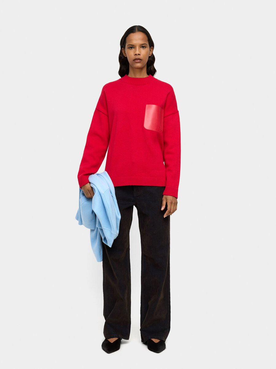 Knit sweater with leather-effect pocket