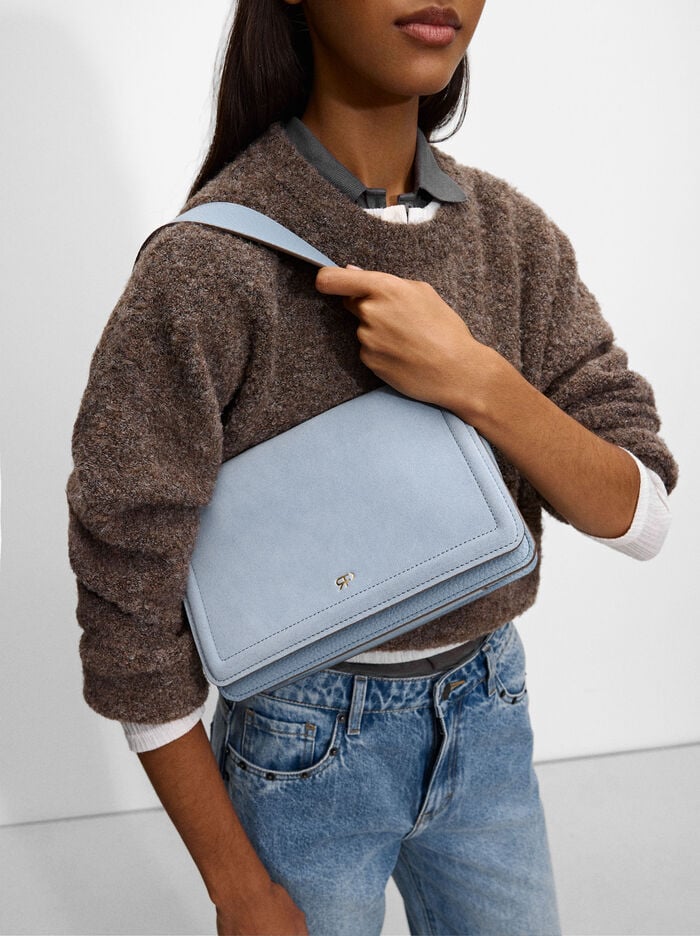Shoulder bag with fur and flap closure