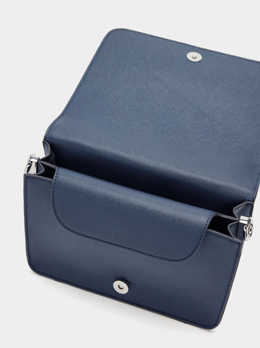 Crossbody bag with texture and flap closure