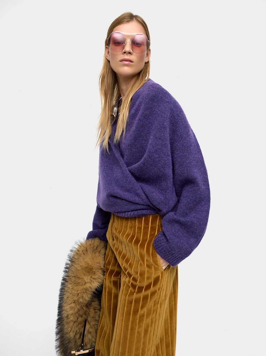 Knit sweater with crossover