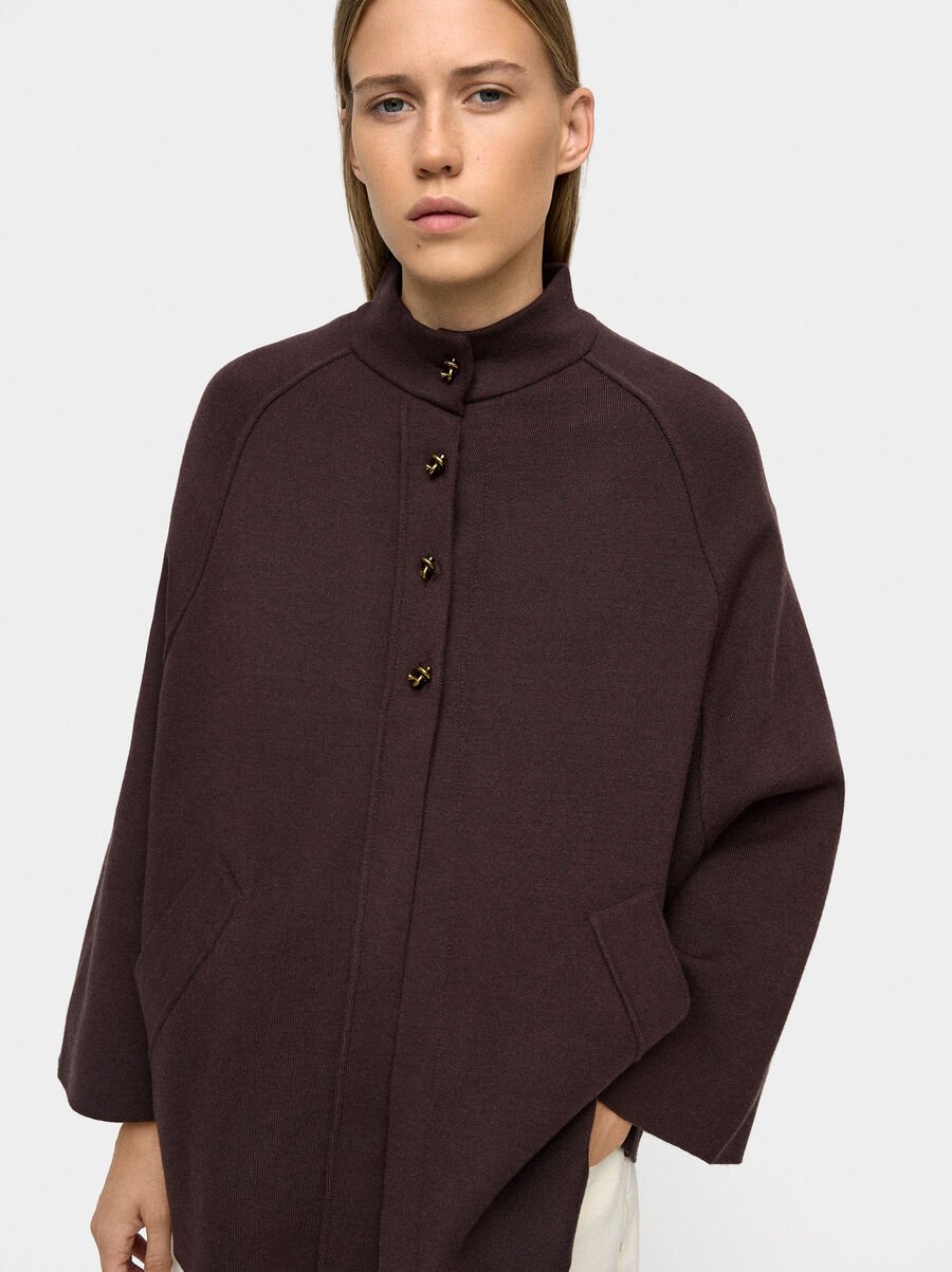 Knit poncho with high neck