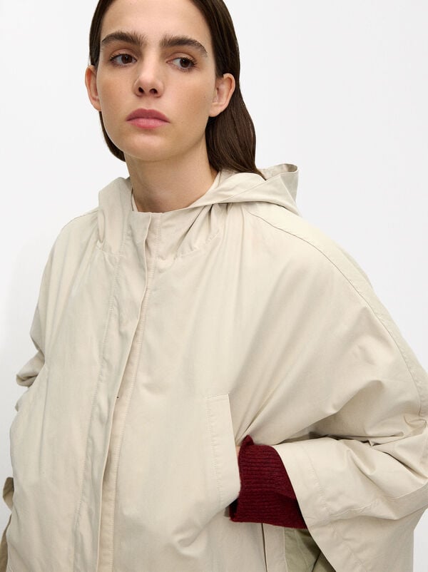 Cape with hood and pockets