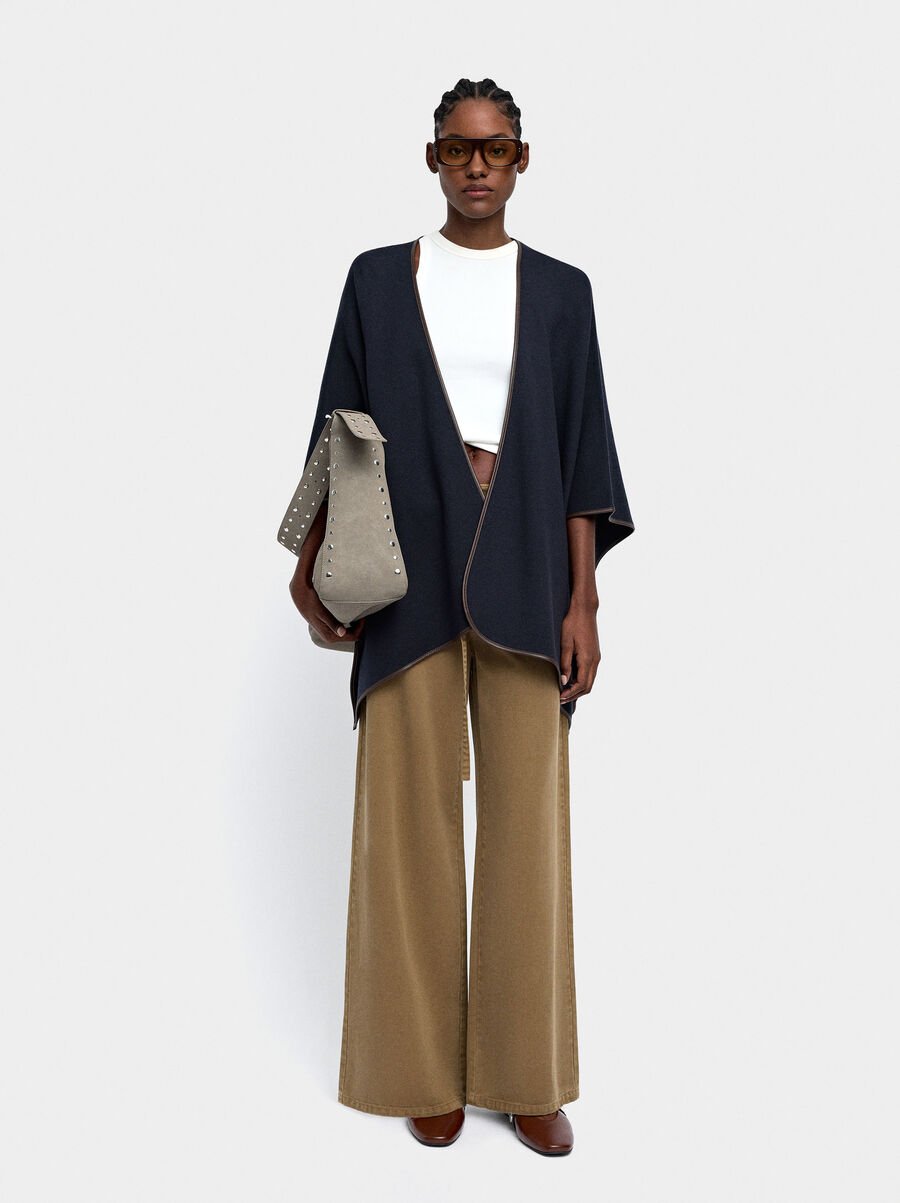 Knitted poncho with stitching detail