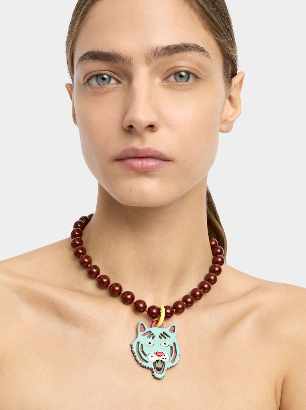 Necklace of beads with tiger pendant