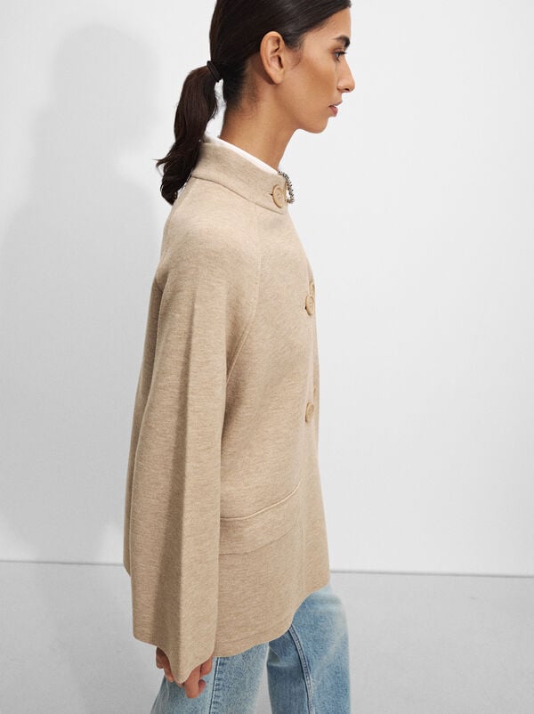 Knitted poncho with buttons
