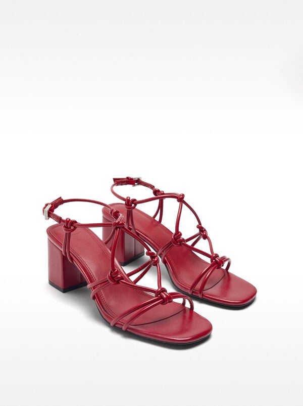 Heeled sandals with straps and knots