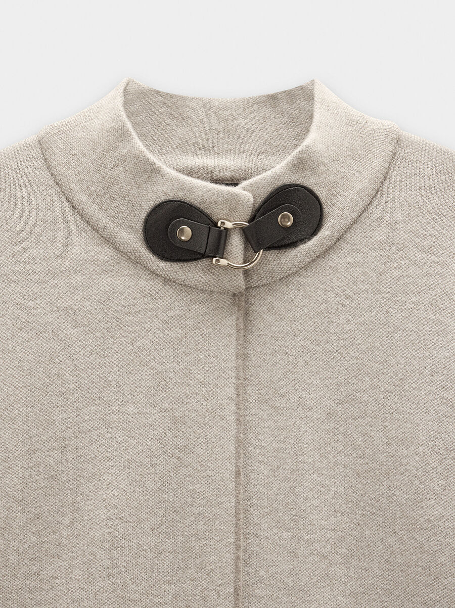 Knitted poncho with stitching detail