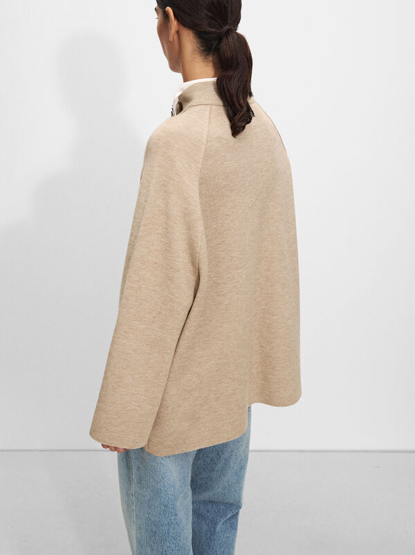 Knitted poncho with buttons