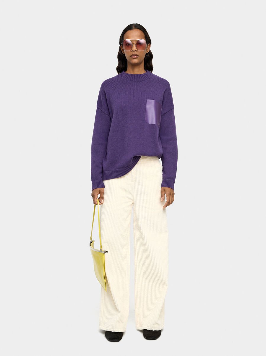 Knit sweater with leather-effect pocket