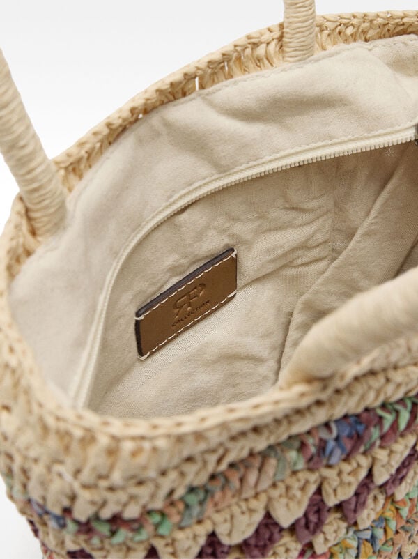 Handbag with crossbody strap straw effect