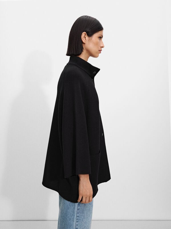 Knitted poncho with buttons