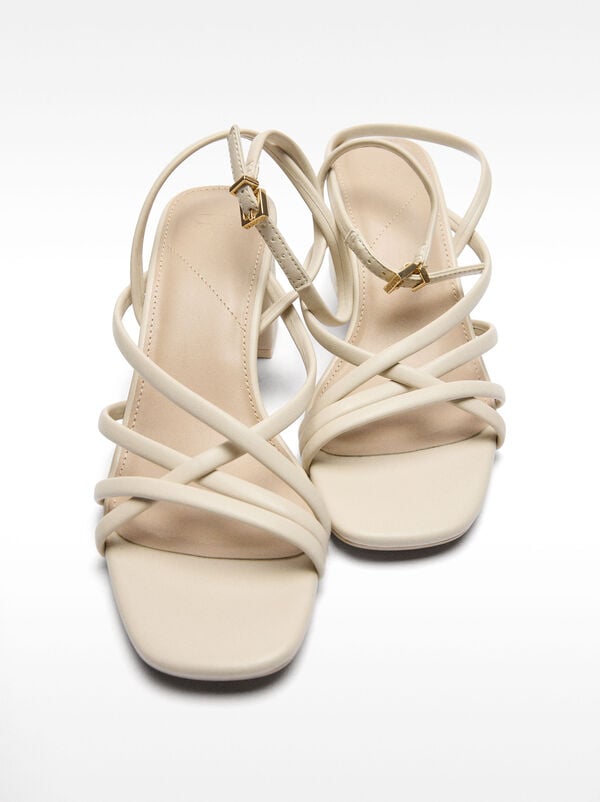 Heeled sandals with crossed straps