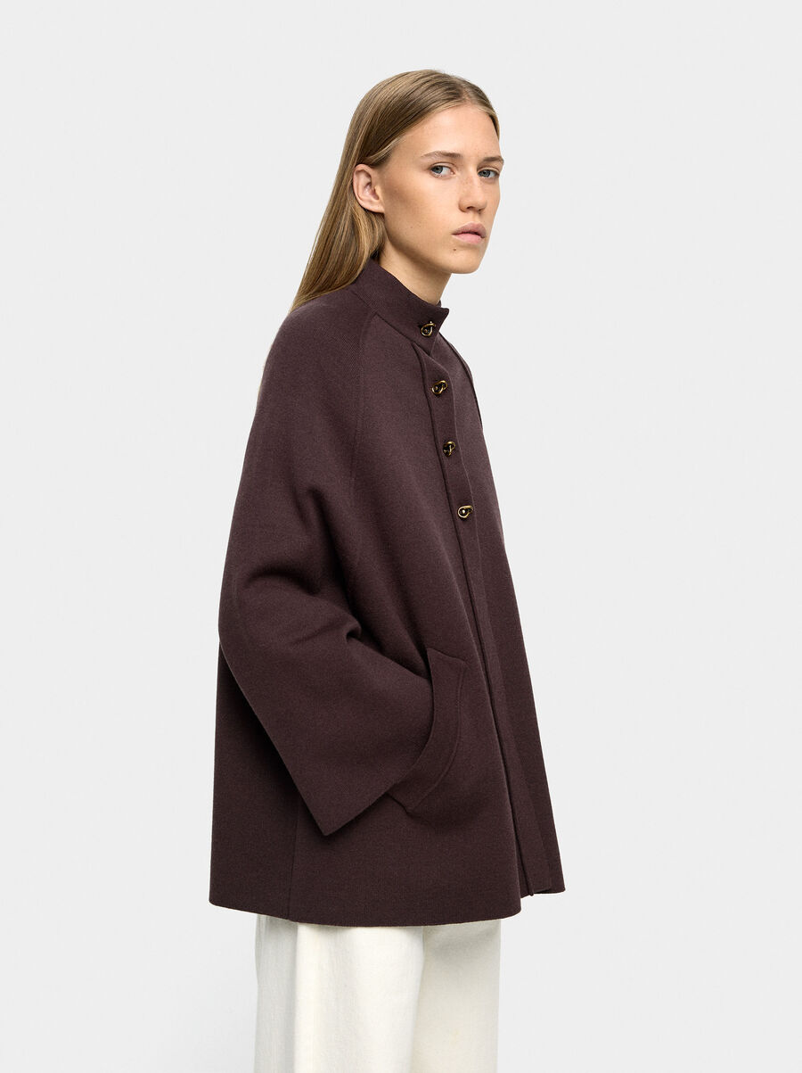 Knit poncho with high neck