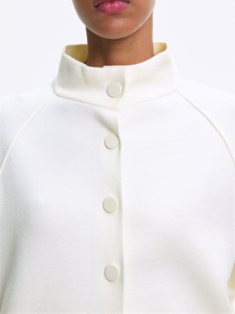 Knitted poncho with buttons
