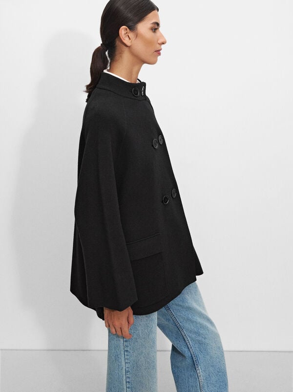 Knitted poncho with buttons