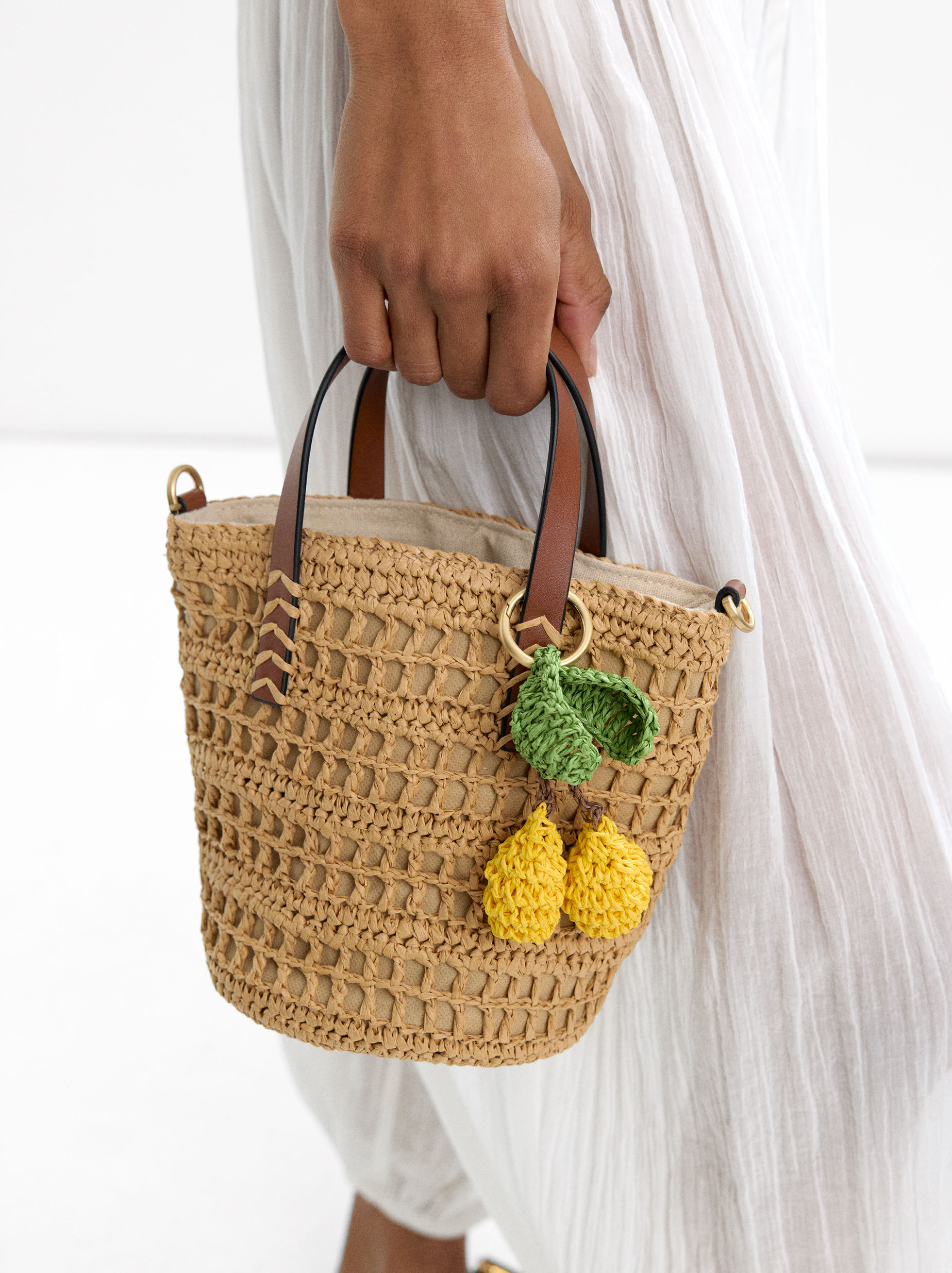 Straw-effect bucket bag with hanging detail image number 1.0