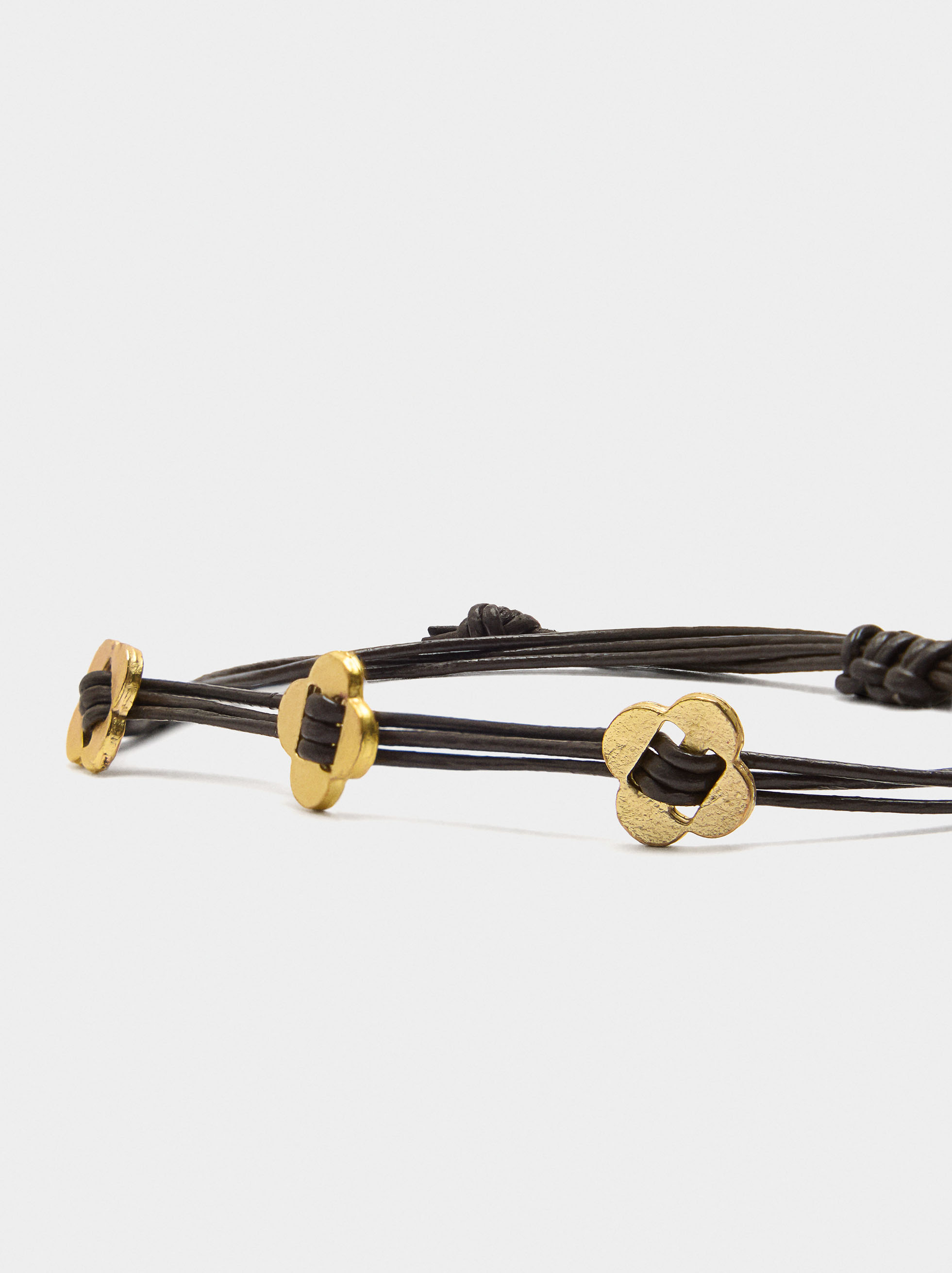 Leather cord bracelet with flower charms image number 1.0