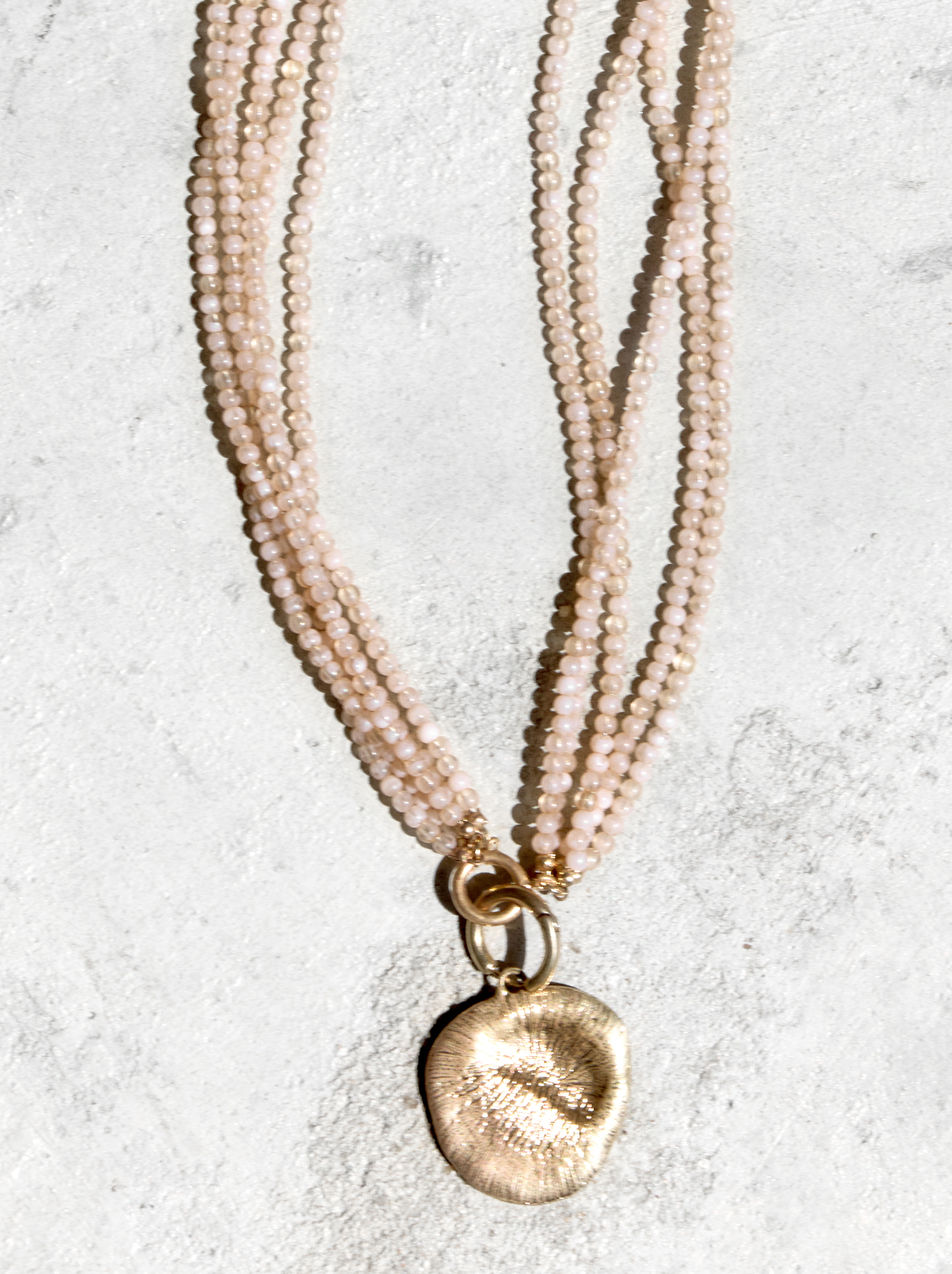 Multi-strand necklace with medal